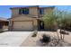 Charming two-story home featuring desert landscaping, a two-car garage, and a well-manicured lawn at 1091 W West Virginia Ave, Florence, AZ 85132
