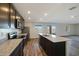 Modern kitchen featuring granite countertops, dark cabinetry, an island, and stainless steel appliances at 1091 W West Virginia Ave, Florence, AZ 85132