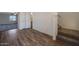 View of the hall area with a staircase and entryway to another room, showcasing the design at 1091 W West Virginia Ave, Florence, AZ 85132