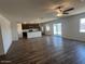 Open-concept living room and kitchen featuring luxury vinyl flooring and abundant natural light at 1091 W West Virginia Ave, Florence, AZ 85132