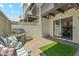 Charming backyard with patio, seating, grill, and artificial turf area, perfect for outdoor living at 11011 N 92Nd St # 1005, Scottsdale, AZ 85260