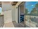 Cozy balcony with sliding glass doors leading to an office featuring a blue futon and black desk at 11011 N 92Nd St # 1005, Scottsdale, AZ 85260