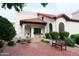 Building exterior with red tile roof and brick-paved walkway leading to covered entry with bench seating at 11011 N 92Nd St # 1005, Scottsdale, AZ 85260