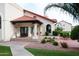 Exterior building shot with red tile roof featuring a covered entryway with courtyard, bench seating, and beautiful greenery at 11011 N 92Nd St # 1005, Scottsdale, AZ 85260