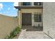 Charming entryway with double doors, stone columns and pavers, with desert landscaping in the front at 11011 N 92Nd St # 1005, Scottsdale, AZ 85260
