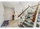 Bright foyer with tile flooring, staircase, and a built-in bar area, next to the entryway at 11011 N 92Nd St # 1005, Scottsdale, AZ 85260