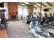 Community gym features workout machines, free weights, exposed brick wall, and arched windows for plenty of natural light at 11011 N 92Nd St # 1005, Scottsdale, AZ 85260