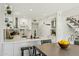 Modern kitchen with white cabinets, countertops, and island with seating next to a dinette area at 11011 N 92Nd St # 1005, Scottsdale, AZ 85260