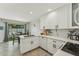 Bright kitchen with white cabinets, marble backsplash, stainless appliances, and dining area with natural light at 11011 N 92Nd St # 1005, Scottsdale, AZ 85260