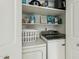 Convenient laundry area with modern washer and dryer, built-in shelving and plenty of storage space at 11011 N 92Nd St # 1005, Scottsdale, AZ 85260