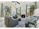 Bright living room featuring large arched windows, fireplace, high ceilings, and comfortable seating at 11011 N 92Nd St # 1005, Scottsdale, AZ 85260