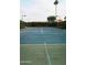 Well maintained community tennis court surrounded by lush landscaping and tall trees, providing a private space at 11011 N 92Nd St # 1005, Scottsdale, AZ 85260