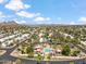 Scenic aerial shot of a community pool area surrounded by palm trees and well-kept residences and desert vistas at 113 E Boca Raton Rd, Phoenix, AZ 85022