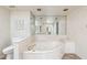 Bright bathroom with large soaking tub, toilet and vanity with mirror at 113 E Boca Raton Rd, Phoenix, AZ 85022