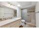Bright bathroom featuring vanity, toilet, and shower with a glass door at 113 E Boca Raton Rd, Phoenix, AZ 85022