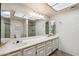 Bright bathroom featuring dual sinks, spacious vanity, shower with glass door and a skylight at 113 E Boca Raton Rd, Phoenix, AZ 85022