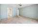Spacious carpeted bedroom featuring a ceiling fan and an ensuite bathroom for added privacy and comfort at 113 E Boca Raton Rd, Phoenix, AZ 85022