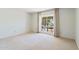 Light-filled bedroom with a large window overlooking the outdoors and neutral carpet at 113 E Boca Raton Rd, Phoenix, AZ 85022