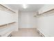 Large walk-in closet with built-in shelving and two benches at 113 E Boca Raton Rd, Phoenix, AZ 85022