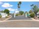 View of the neighborhood entry featuring brick pillars, iron gates and mature landscaping at 113 E Boca Raton Rd, Phoenix, AZ 85022
