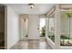 Bright foyer with tile flooring, modern lighting, and large windows offering courtyard views at 113 E Boca Raton Rd, Phoenix, AZ 85022