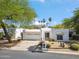 Inviting home featuring desert landscaping, a two-car garage, and charming black and white striped awnings at 113 E Boca Raton Rd, Phoenix, AZ 85022