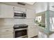 Well-lit kitchen with stainless steel oven, microwave, and sleek countertops at 113 E Boca Raton Rd, Phoenix, AZ 85022