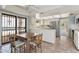 Eat-in kitchen with stainless steel appliances, white cabinetry, and breakfast bar seating at 113 E Boca Raton Rd, Phoenix, AZ 85022