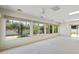 Bright living room with multiple windows offering views of the landscaped backyard at 113 E Boca Raton Rd, Phoenix, AZ 85022