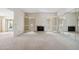 Bright living room with fireplace, access to the backyard, and mirror wall at 113 E Boca Raton Rd, Phoenix, AZ 85022