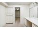 Bright room with an adjacent vanity, built in shelving and carpeted floors at 113 E Boca Raton Rd, Phoenix, AZ 85022