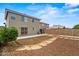 Back of house view with patio and lawn at 11710 W Paradise Dr, El Mirage, AZ 85335
