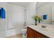 Bright bathroom with white fixtures, tiled floor, and tub with shower at 11710 W Paradise Dr, El Mirage, AZ 85335