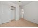 Bright bedroom with closet and neutral carpet at 11710 W Paradise Dr, El Mirage, AZ 85335