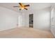 Carpeted bedroom featuring ceiling fan and access to bathroom and walk-in closet at 11710 W Paradise Dr, El Mirage, AZ 85335