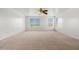 Expansive bedroom featuring bright windows and a ceiling fan at 11710 W Paradise Dr, El Mirage, AZ 85335