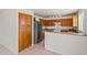 Bright kitchen featuring wood cabinets, stainless steel appliances, breakfast bar and tile flooring at 11710 W Paradise Dr, El Mirage, AZ 85335