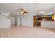 Open-concept living room featuring tile floors and easy access to the kitchen and stairway to second floor at 11710 W Paradise Dr, El Mirage, AZ 85335
