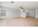 Open living room featuring tile floors and easy access to the stairway and entrance at 11710 W Paradise Dr, El Mirage, AZ 85335