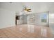 Spacious living room featuring tile floors, a ceiling fan, and sliding glass doors to backyard at 11710 W Paradise Dr, El Mirage, AZ 85335