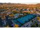 Aerial shot of a community featuring tennis courts, a pool, and lush landscaping at 11993 E Mission Ln, Scottsdale, AZ 85259