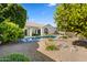 Backyard with a pool, desert landscaping, greenery, and a patio with seating, ideal for outdoor living at 11993 E Mission Ln, Scottsdale, AZ 85259