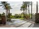 Community entrance with mature trees, desert landscaping, and picturesque mountain views at 11993 E Mission Ln, Scottsdale, AZ 85259