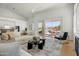 Bright, airy living room with modern decor, hardwood floors and views of the backyard pool and patio area at 11993 E Mission Ln, Scottsdale, AZ 85259