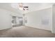 Bright primary bedroom featuring sliding glass doors and new carpet flooring at 12355 W Hadley St, Avondale, AZ 85323