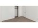 Comfortable bedroom featuring neutral carpet, a closet, and a door to the outside at 12355 W Hadley St, Avondale, AZ 85323