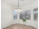 Bright dining area featuring a chandelier and large windows for ample sunlight at 12355 W Hadley St, Avondale, AZ 85323