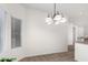 Bright dining area featuring a chandelier and large windows for ample sunlight at 12355 W Hadley St, Avondale, AZ 85323