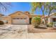 Charming single-story home featuring a two-car garage and low maintenance desert landscaping at 12355 W Hadley St, Avondale, AZ 85323