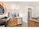 Functional kitchen features wood cabinets and a window looking to the backyard at 12355 W Hadley St, Avondale, AZ 85323